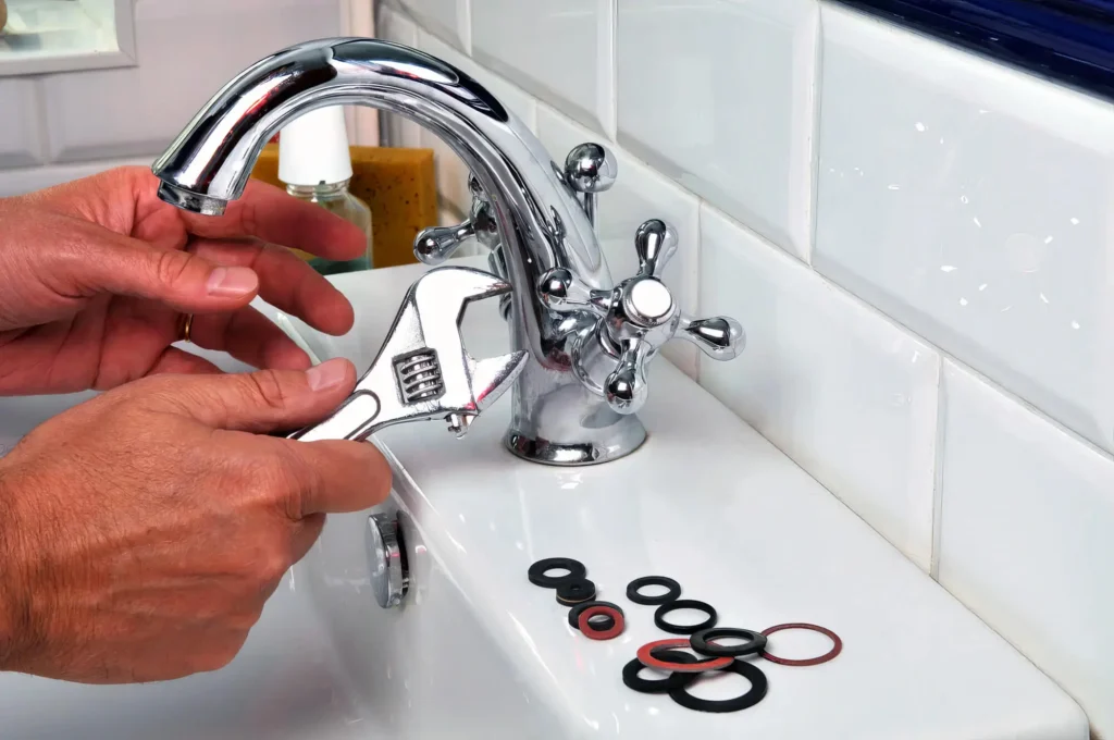 Plumber performing maintenance on a bathroom faucet in Redlands