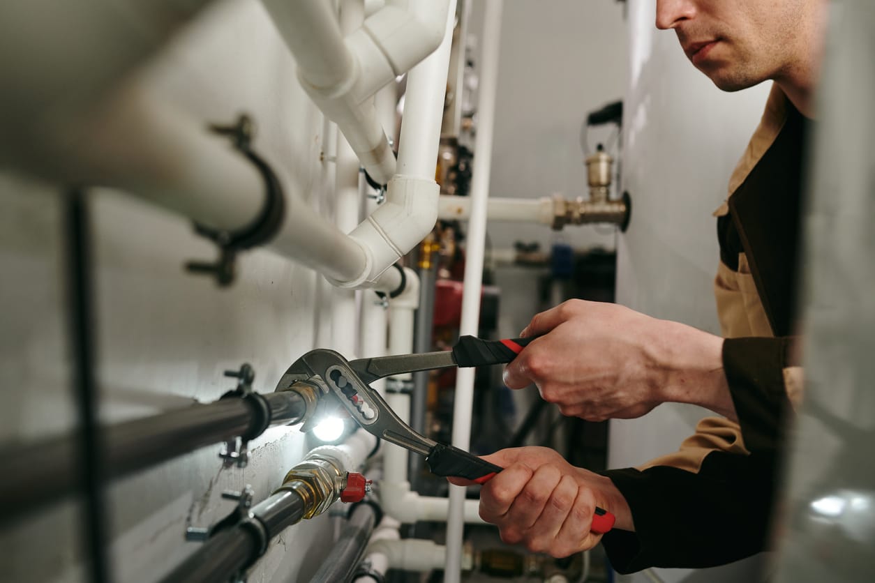 Plumbers maintaining commercial plumbing pipes in Redlands