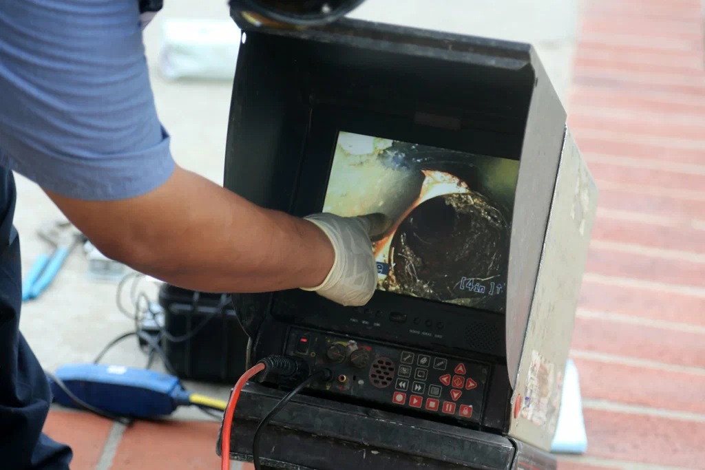 Technician viewing a drain inspection camera in Redlands