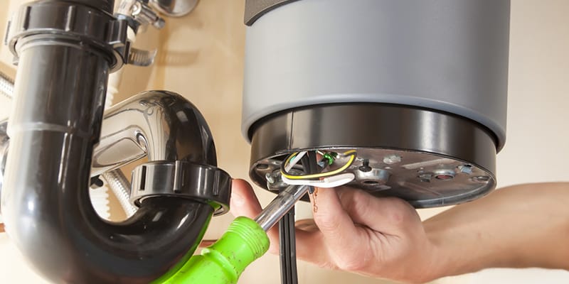Technician repairing the heating element of a water heater in Redlands