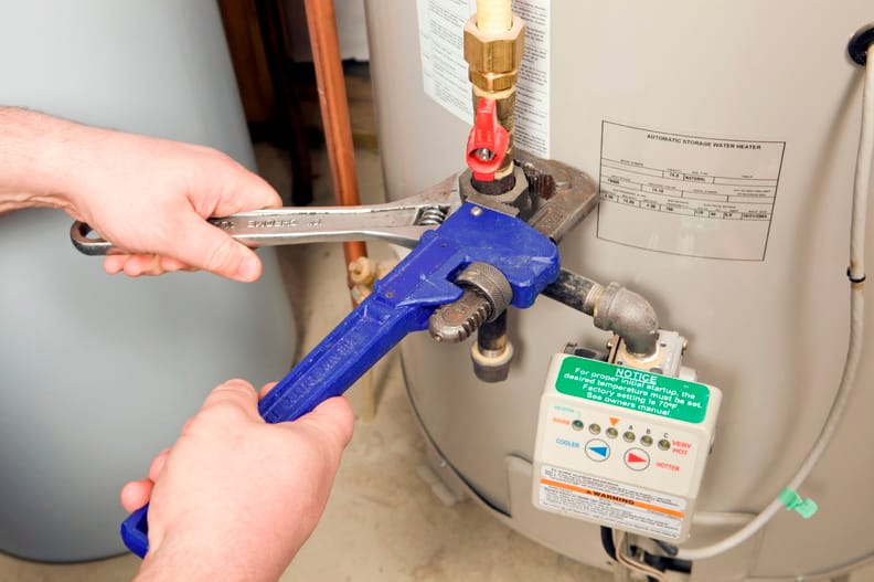 Plumber repairing a water heater valve in Redlands